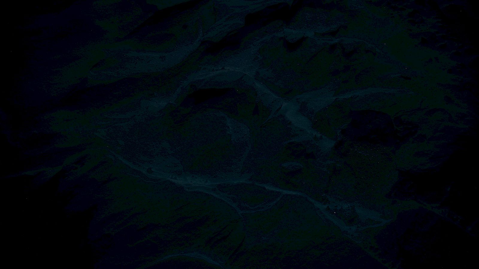 The image is very dark, making it difficult to identify specific details or objects.