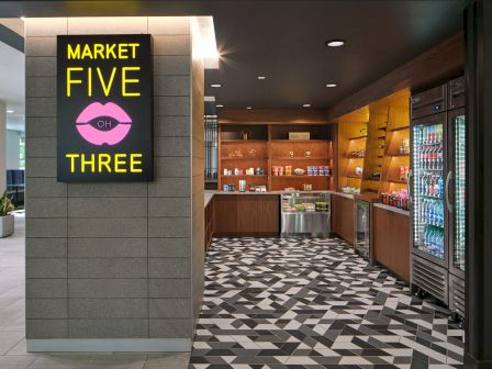 A modern convenience store named "Market Five OH Three" with snacks, drinks, and stylish geometric floor tiles.