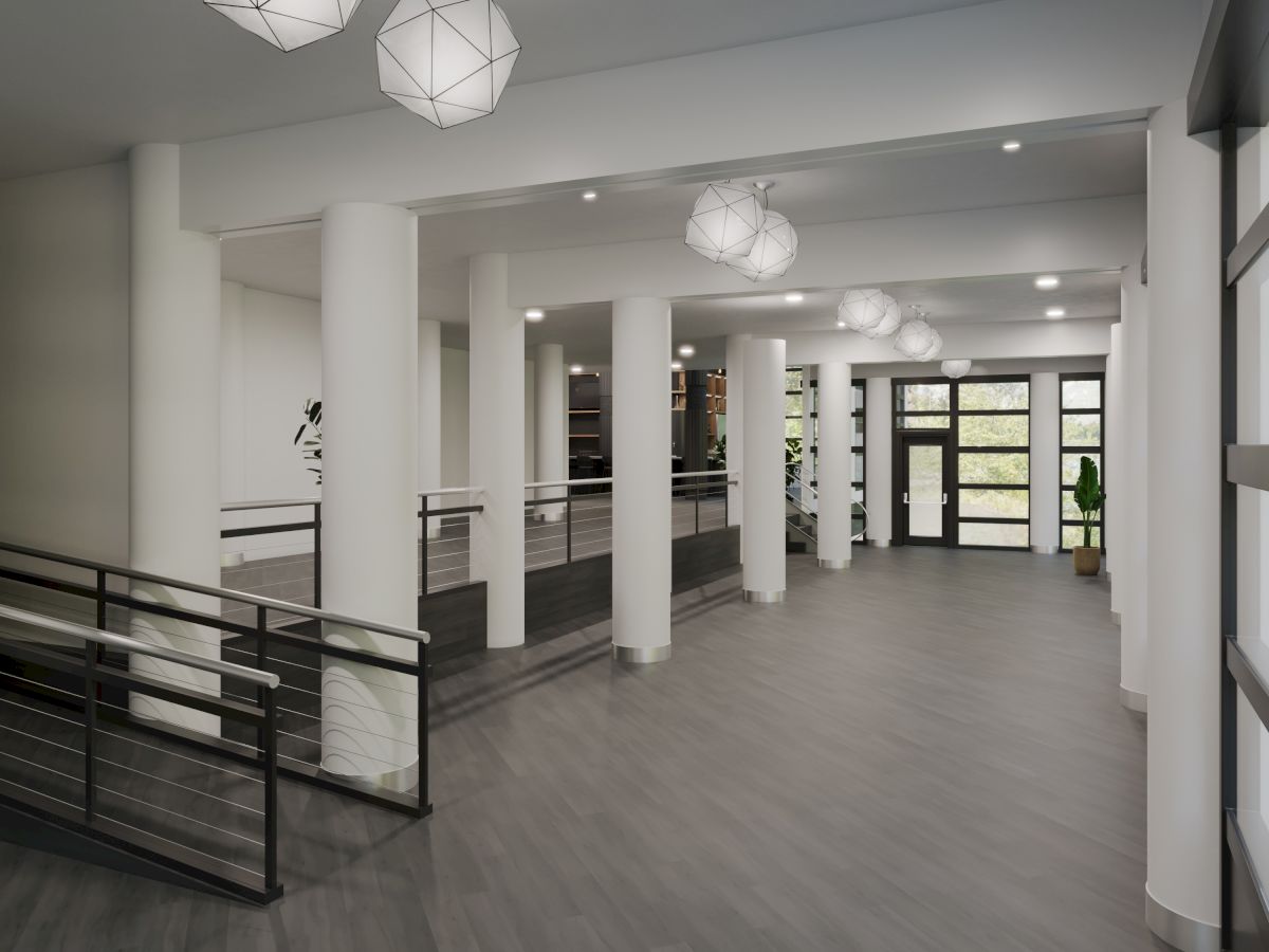 A modern hallway with columns, geometric ceiling lights, and large windows, featuring a staircase with metal railings and a plant.